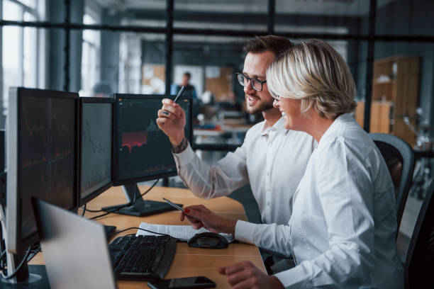 istock Analyzing information together. Two stockbrokers in formal clothes works in the office with financial market 1305286236