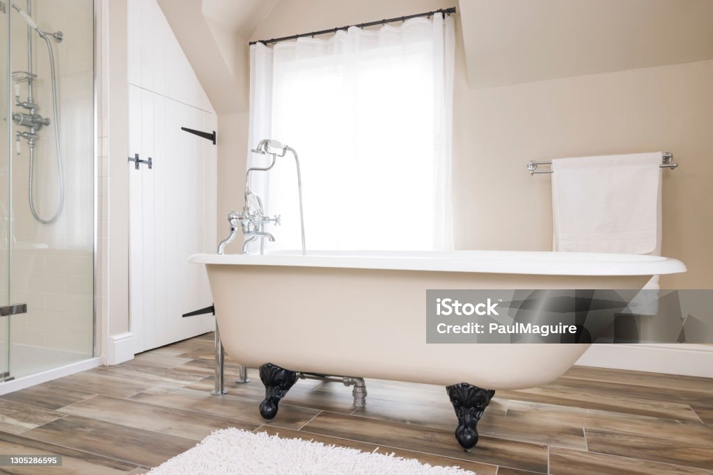 Bathtub, clawfoot or claw foot bath in a luxury bathroom, UK Bathtub, clawfoot or clawfoot bath tub in a modern luxury bathroom interior, UK. Bath time. Bathtub Stock Photo