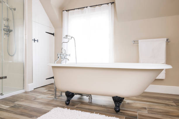 Bathtub, clawfoot or claw foot bath in a luxury bathroom, UK Bathtub, clawfoot or clawfoot bath tub in a modern luxury bathroom interior, UK. Bath time. free standing bath stock pictures, royalty-free photos & images
