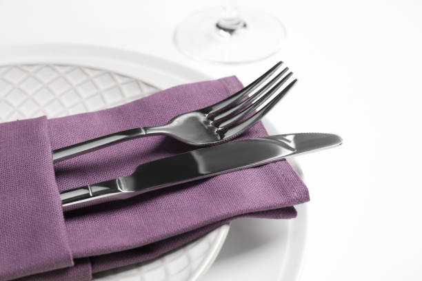 istock Plates with cutlery and napkin on white background, closeup. Table setting 1305287667