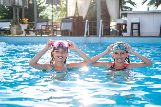 istock Beautiful girls in the pool 1305287800