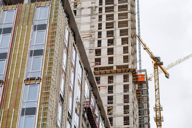 istock Residential high-rise building under construction. Unfinished house on a construction site with cranes. 1305289363