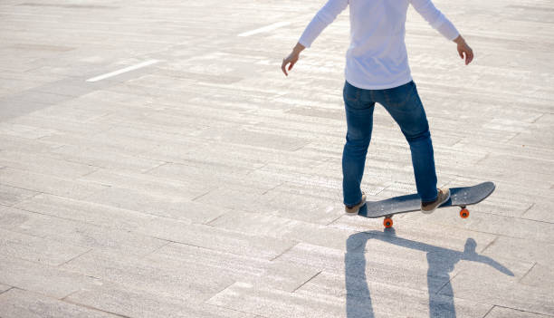 istock Skateboarder skateboarding outdoors on sunny morning 1305290717