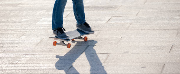 istock Skateboarder skateboarding outdoors on sunny morning 1305290775