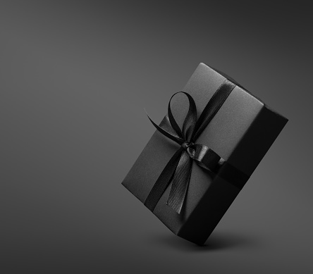 Black Gift box on dark background. This file is cleaned, retouched and contains clipping path..