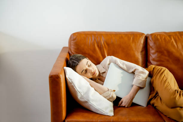 istock Woman fell asleep on the comfortable brown couch. 1305296225