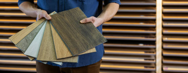 istock flooring store seller with vinyl floor samples in hands. copy space 1305296345