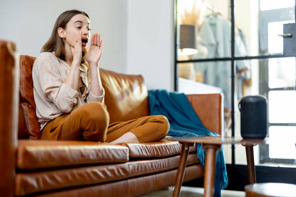 istock Woman speaking with audio assistant column on sofa 1305297745