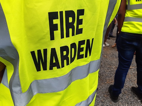 Yellow jacket showing fire warden on duty. Safety background