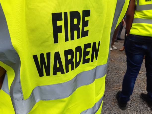 Yellow jacket showing fire warden on duty. Safety background. Yellow jacket showing fire warden on duty. Safety background fire natural phenomenon stock pictures, royalty-free photos & images