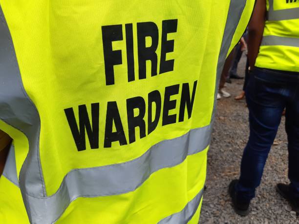 Yellow jacket showing fire warden on duty. Safety background. Yellow jacket showing fire warden on duty. Safety background drill team stock pictures, royalty-free photos & images