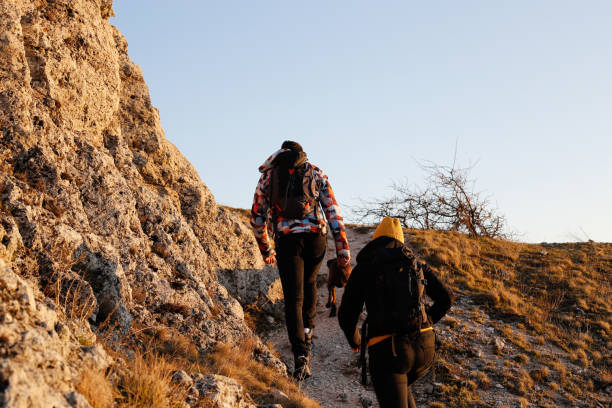 istock Siblings hike along footpath on mountain ridge stock photo 1305299037