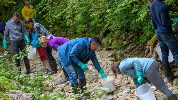 istock Volunteers picking up trash in forest 1305300653