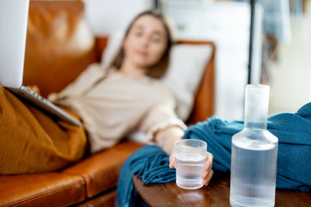 istock Woman working on laptop and lying on sofa 1305301767