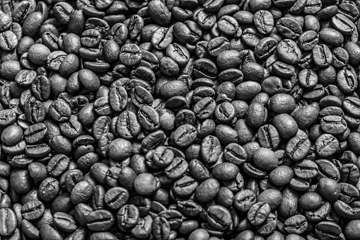 Roasted coffee beans isolated close up on black background, clipping path