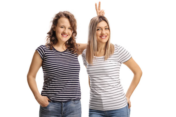 istock Female friends posing and making bunny ears on head 1305302219