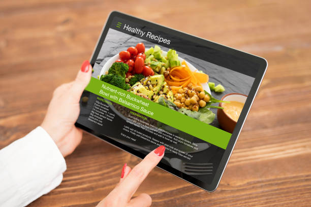 istock Woman browsing meal recipes on tablet 1305304321