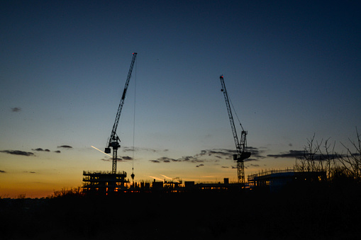 A sunset behind a large construction site in Walthamstow in London