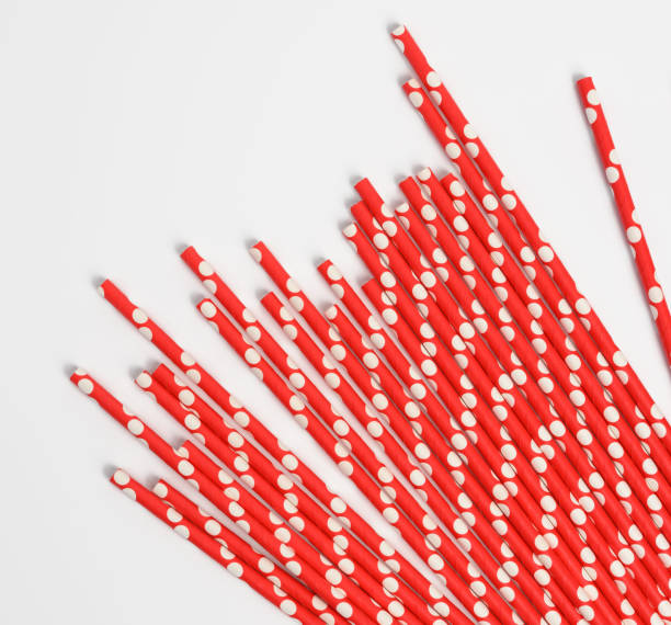 istock red paper straws for a cocktail on a white background 1305307920