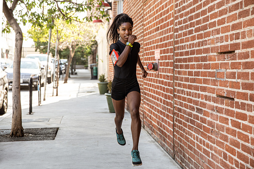 Afro american woman running outdoors