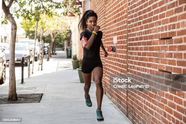Athletic Woman Running Outdoors Stock Photo - Download Image Now - Running, Women, One Woman Only
