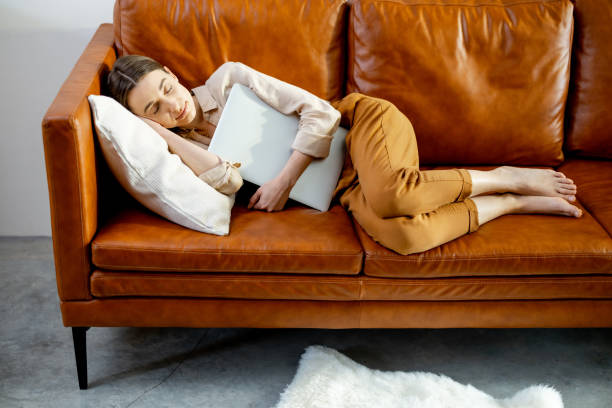 istock Woman fell asleep on the comfortable brown couch. 1305310072