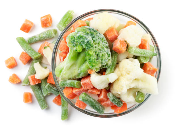 istock Frozen vegetables in a plate and sprinkled on a white. Top view. 1305310939