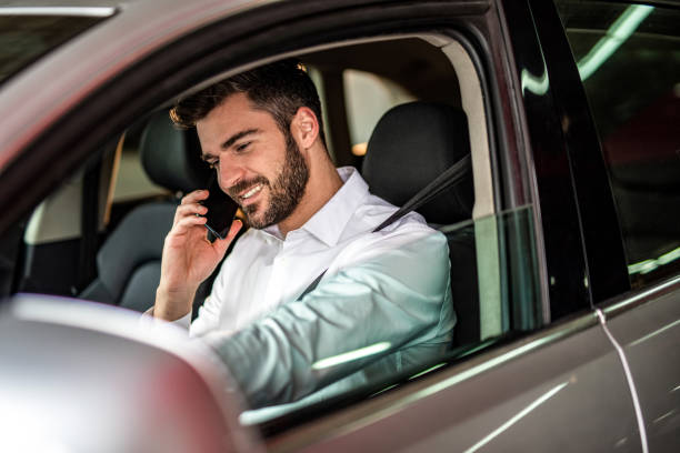 istock Man driving a car in public garage. 1305312466