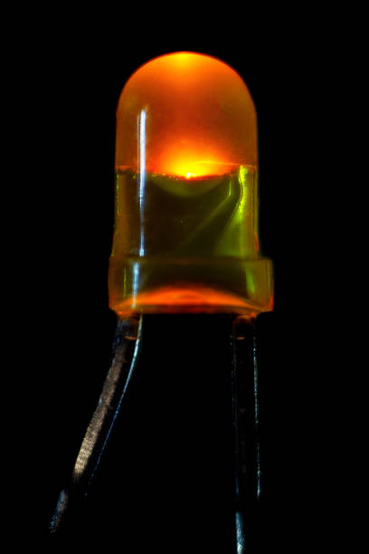 istock Glowing yellow LED with a diameter of 3 mm on a black background 1305312600