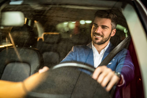 istock Man driving a car in public garage. 1305313578