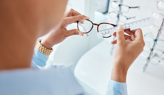 Shot of an optometrist measuring a pair of glasses with a pd ruler