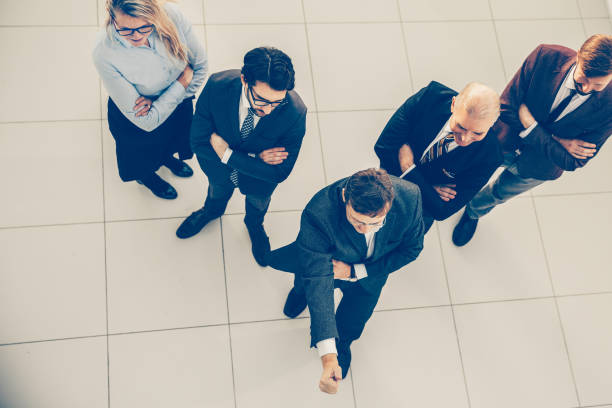 istock top view. a group of successful employees standing in the office 1305314093
