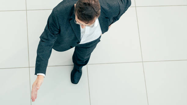 istock top view. confident business man holding out his hand for a handshake 1305314100