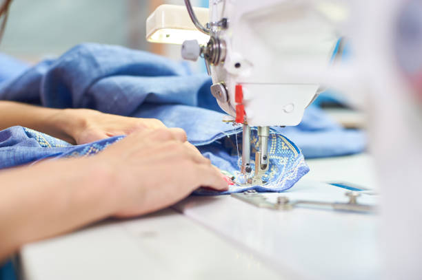 istock Industrial sewing machine and hand seamstress. Close-up 1305314110
