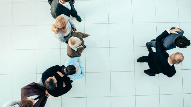 istock top view. leaders standing in front of a big business team 1305314150