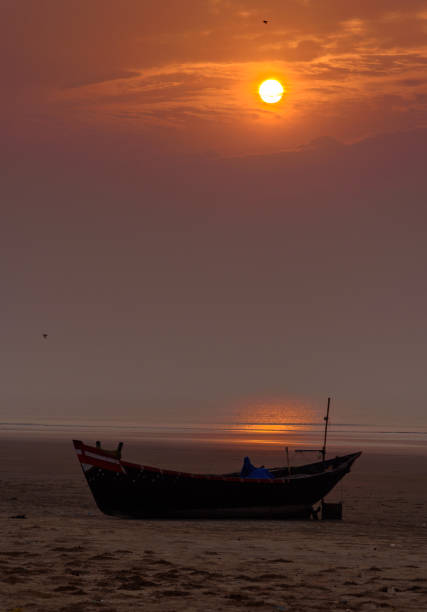 Fishing Boat. Silhouette of A Fishing boat on the Beach. Selective Focus is used. odisha stock pictures, royalty-free photos & images