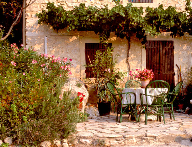 A quaint, pretty garden scene, with rustic patio furniture stock photo