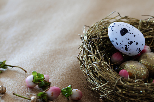 Close up of a golden easter basket filled with eggs. easter background