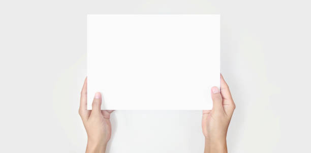 istock Hands holding paper blank for letter paper 1305316240