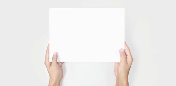 Hands holding paper blank for letter paper stock photo