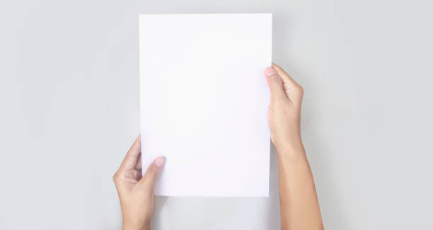 istock Hands holding paper blank for letter paper 1305316242