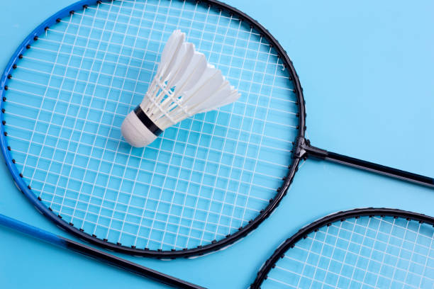 istock Shuttlecock and badminton rackets on blue background. 1305316930