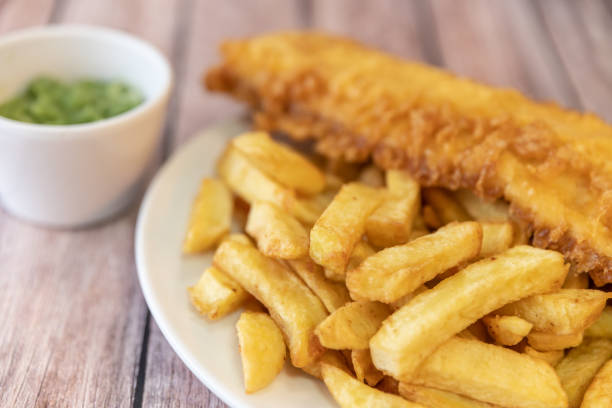 istock Close up of fish and chips with mushy peas 1305317985