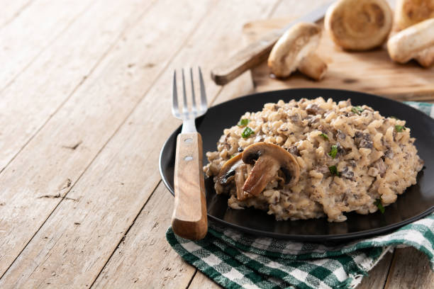 istock Risotto with mushroom on black plate 1305319482