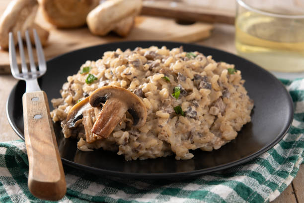 istock Risotto with mushroom on black plate 1305319519