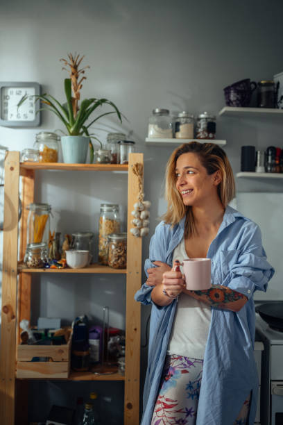istock Beautiful woman drinking coffee at home 1305322641