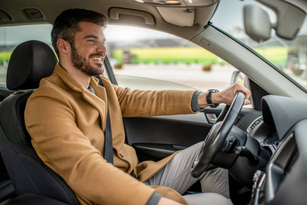 istock Young man driving a car. 1305324781