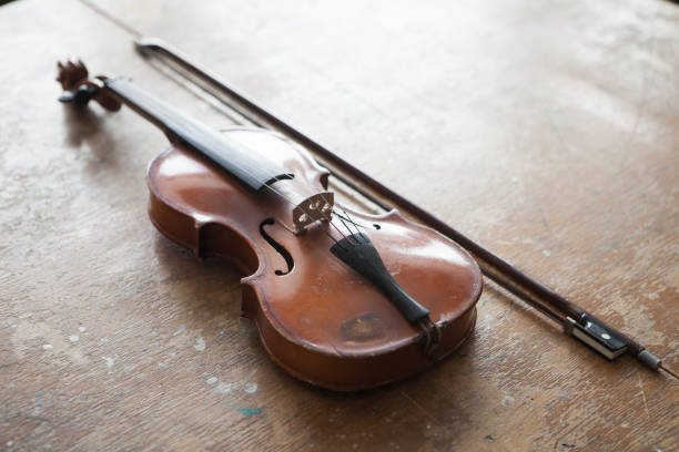 istock Violin in vintage style on wood background 1305324822