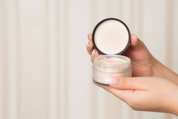 istock Woman hand holding light loose powder 1305326094