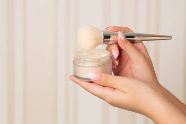 istock Woman using light mineral powder with a brush 1305326116